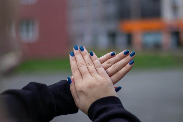person with blue manicure and blue manicure